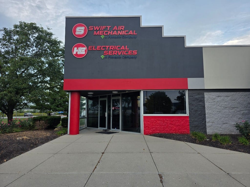 Swift Air Mechanical and H.E. Electrical Services entrance signage on drivit fascia