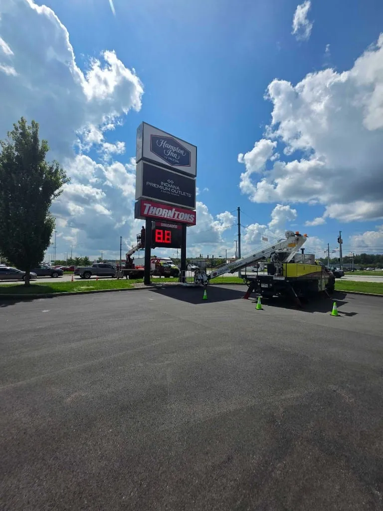 Thorntons pylon sign repair with Midwest Signs bucket truck crew