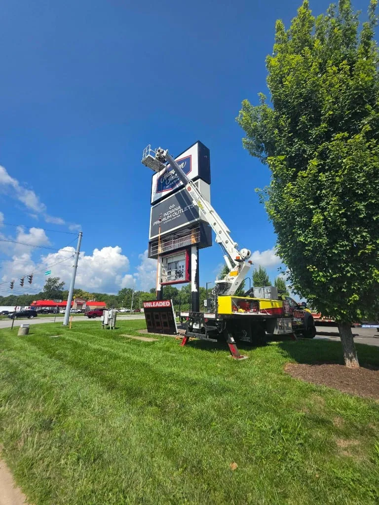 Midwest Signs bucket truck servicing Thorntons pole sign